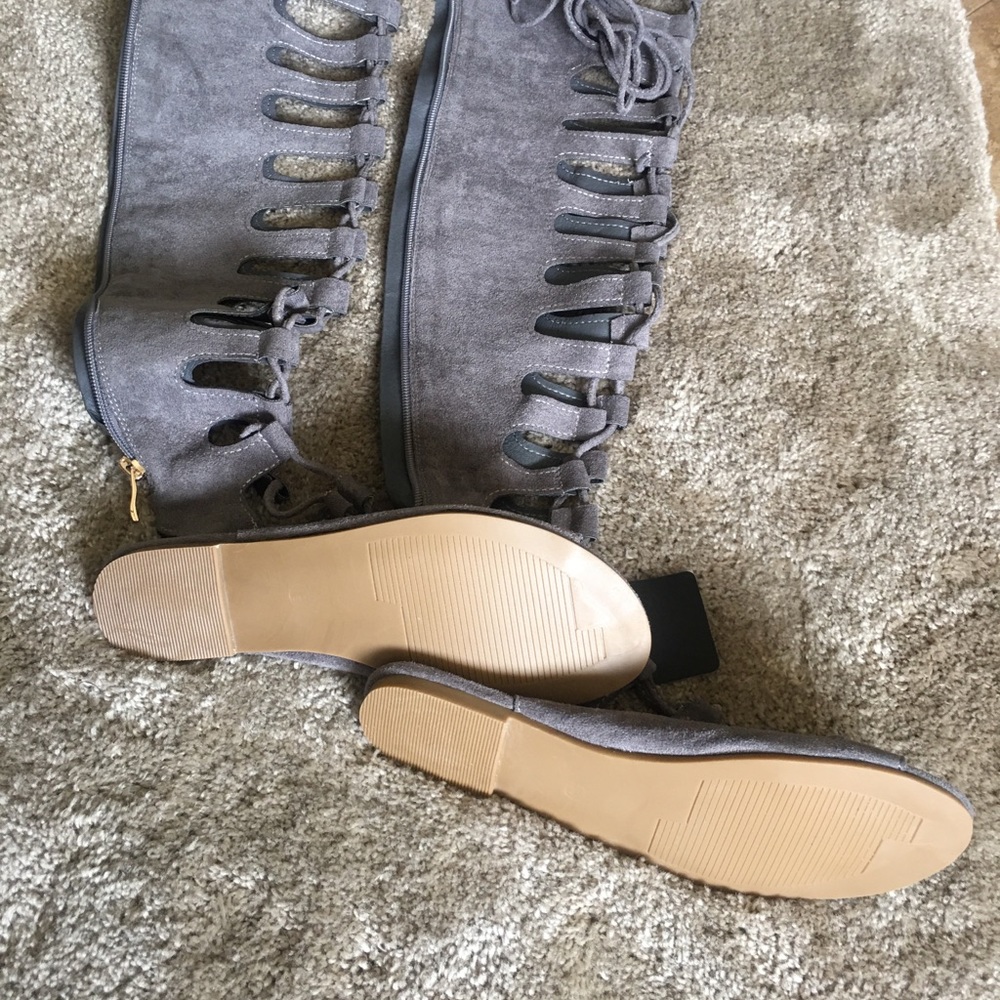 Over the knee lace-up front gladiator sandals .